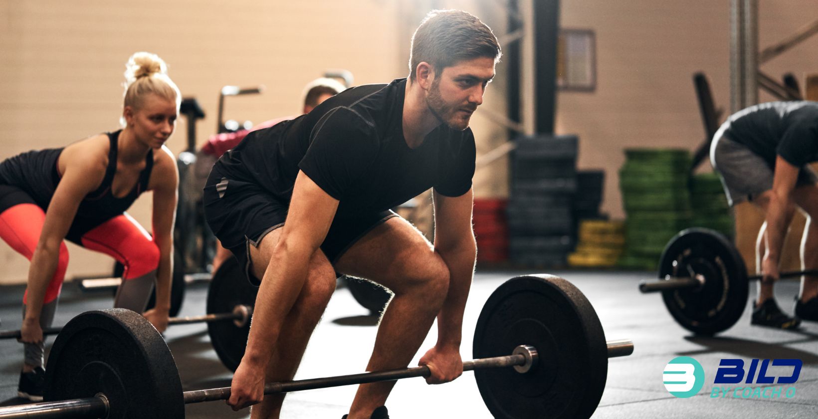 Benefits of strength training demonstrated by man lifting weights at BILD by Coach O gym in Naples FL