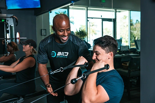Coach O training a man at BILD Naples Family Fitness