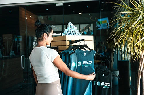 Naples Family Fitness Woman looking at apparel at Bild By Coach O