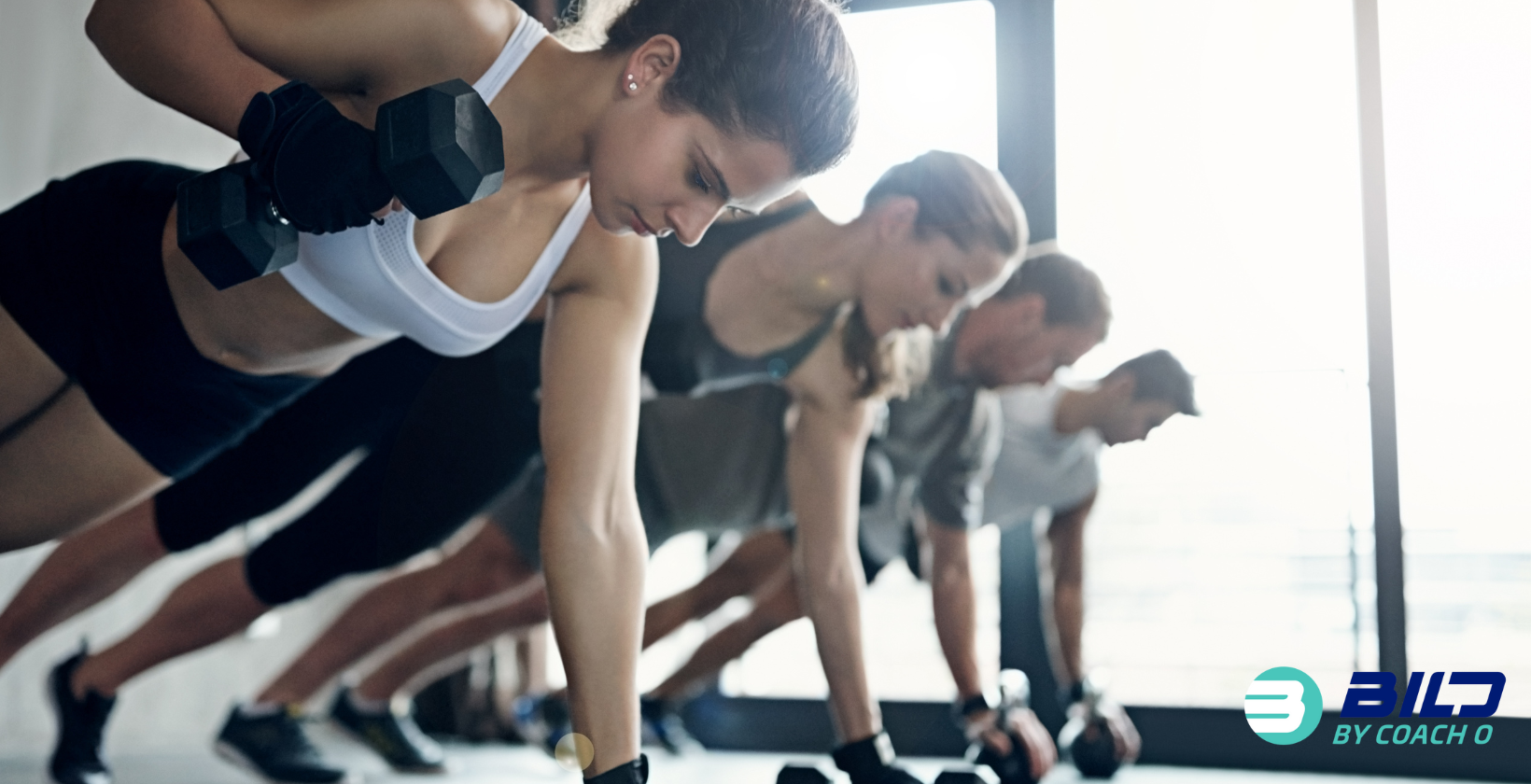 Strength training coach working with client at BILD by Coach O gym in Naples FL