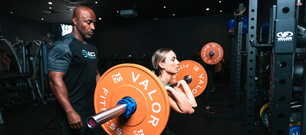 Coach O guiding a barbell training session at BILD by Coach O, one of the top gyms in Naples FL