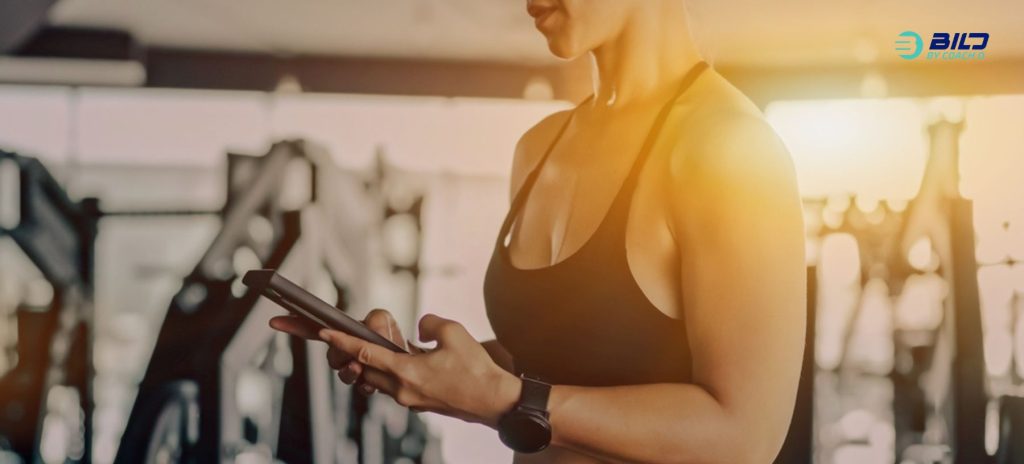 Women use mobile in the gym